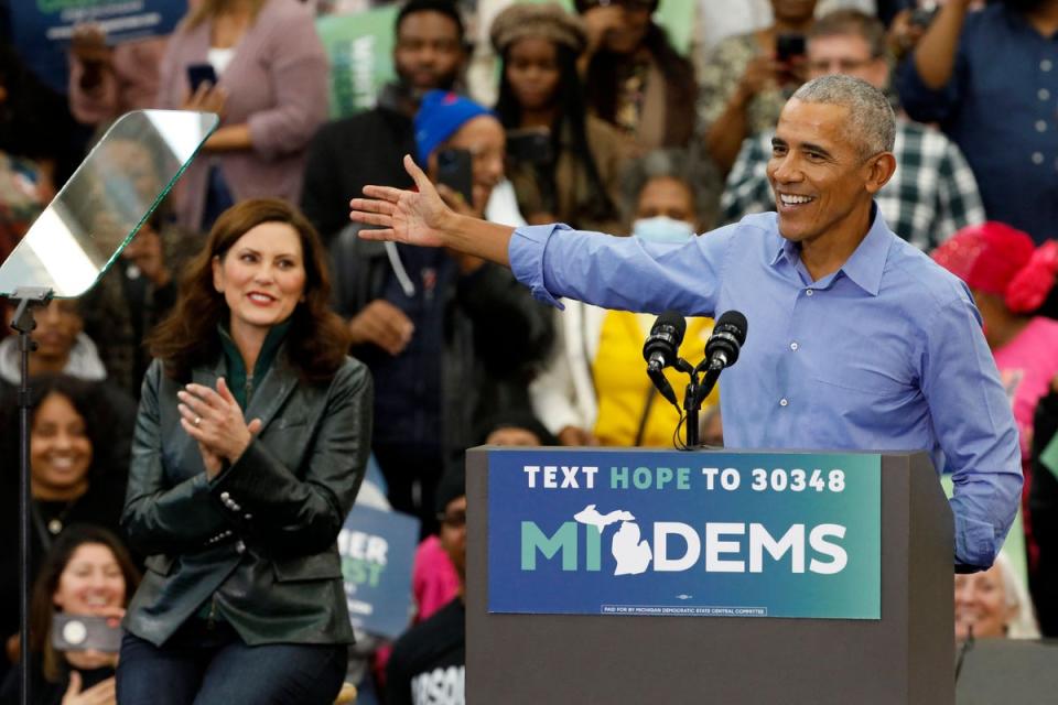 Former US President Barack Obama campaigns for Michigan Governor Gretchen Whitmer (L) during a 