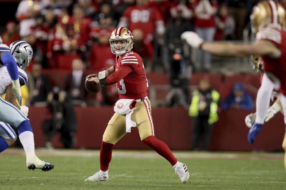 San Francisco 49ers quarterback Brock Purdy (13) looks to pass during an NFL divisional round playoff football game against the Dallas Cowboys, Sunday, Jan. 22, 2023, in Santa Clara, Calif. (AP Photo/Scot Tucker)