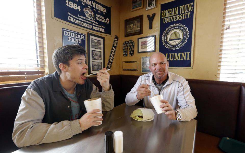 In this Feb. 14, 2014 photo, Ryan Campbell looks on while having lunch with his son in Lehi, Utah. Campbell is one of dozens of Utah parents considering divorce who have taken a course on their legal options and how the split will affect their children. A Utah lawmaker is proposing ramping up the law to cut down on the number of divorces in the state. Under a proposed measure in the state Legislature, couples would have to take the class earlier, before a court can grant custody rights. (AP Photo/Rick Bowmer)