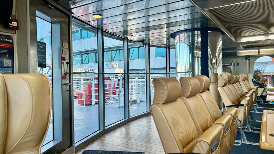 A row of leather seats in front of windows on the Victoria clipper ferry