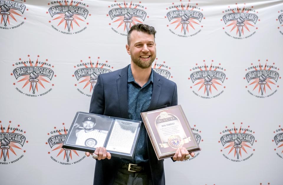 Former Chicago Cubs and Kansas City Royals star Ben Zobrist poses for photos with his plaques from the induction ceremony for the 2023 Greater Peoria Sports Hall of Fame on Saturday, March 25, 2023 at the Peoria Civic Center.