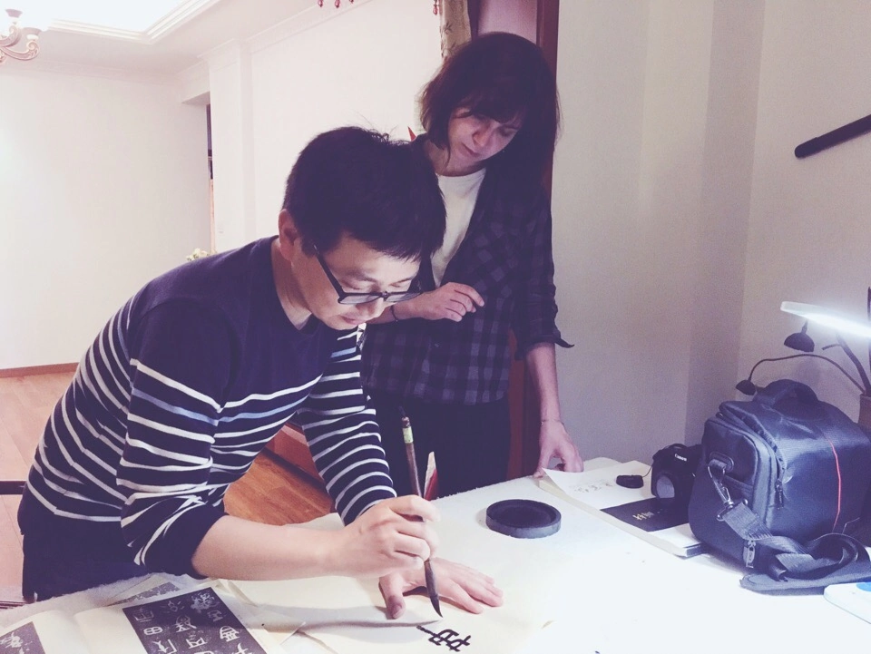 The husband of my Chinese friend teaches me Chinese calligraphy.