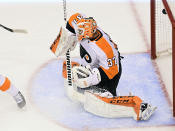 The puck gets past Philadelphia Flyers goaltender Brian Elliott (37) for a goal by New York Islanders center Brock Nelson during the second period of an NHL Stanley Cup Eastern Conference playoff hockey game, Sunday, Aug. 30, 2020, in Toronto. (Frank Gunn/The Canadian Press via AP)