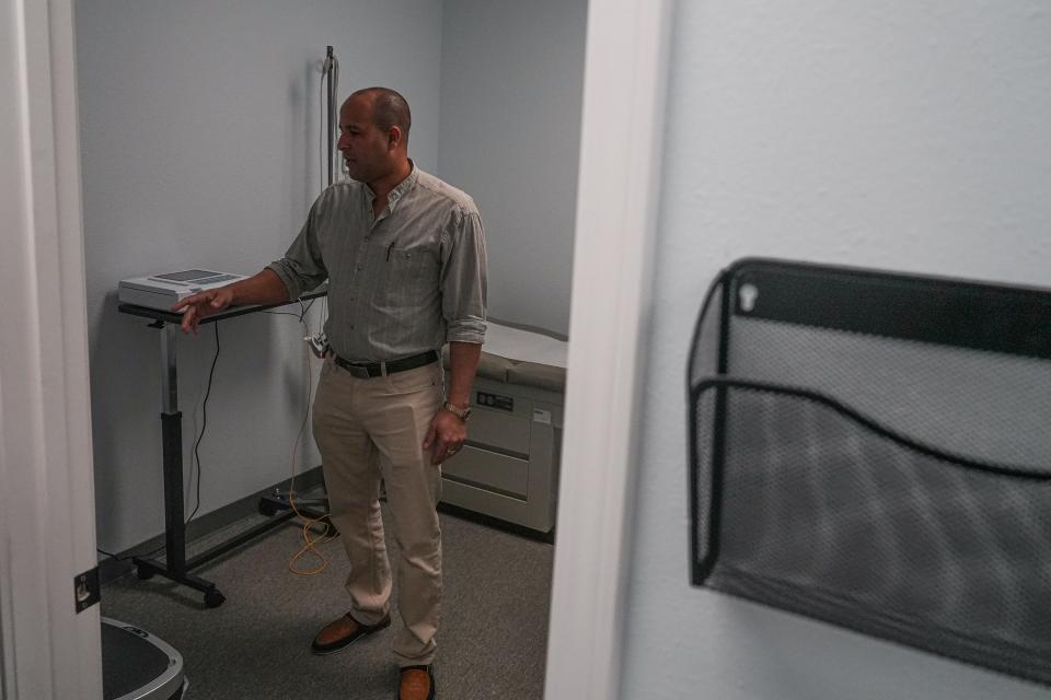 Carlos Pullido, co-owner and manager of Clinica Hispana Rubymed, shows an exam room at the Round Rock clinic.