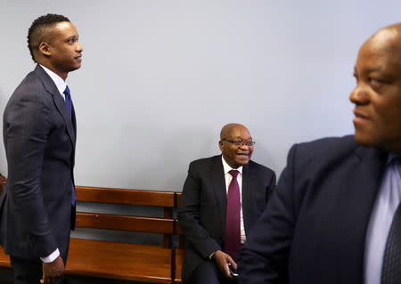 FILE PHOTO: Duduzane Zuma, next to his father, former South African president Jacob Zuma, looks on ahead of his appearance at the Specialised Commercial Crimes Court in Johannesburg, South Africa, January 24, 2019. REUTERS/Siphiwe Sibeko/File Photo