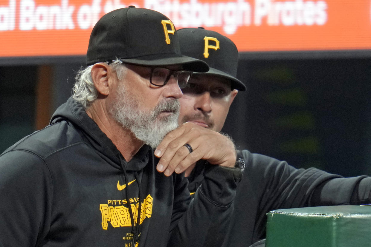 Pittsburgh Pirates manager Derek Shelton, left, and bench coach Don Kelly stand in the dugout during the second inning of a baseball game against the Milwaukee Brewers in Pittsburgh, Tuesday, Sept. 24, 2024. (AP Photo/Gene J. Puskar)