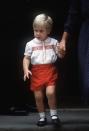 <p>Prince William, 2, leaves St. Mary's Hospital after visiting his newborn brother, Prince Harry. William's son, Prince George, would wear a similar outfit in 2015 at Princess Charlotte's christening.</p>