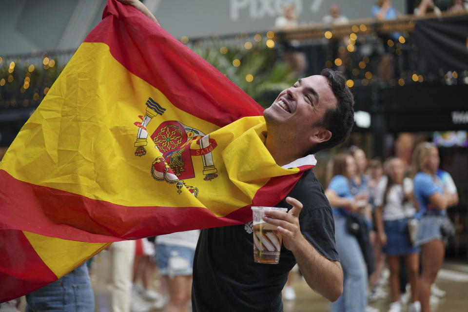 A Spanish fan celebrates after seeing Spain winning against England during a screening of the Women's World Cup final at at BOXPARK Wembley in London, Sunday Aug. 20, 2023. (Lucy North/PA via AP)