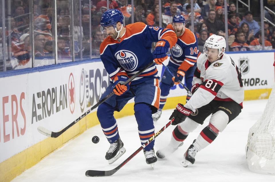 Ottawa Senators' Dominik Kubalik (81) and Edmonton Oilers' Evan Bouchard (2) vie for the puck during the first period of an NHL hockey game Saturday, Jan. 6, 2024, in Edmonton, Alberta. (Jason Franson/The Canadian Press via AP)