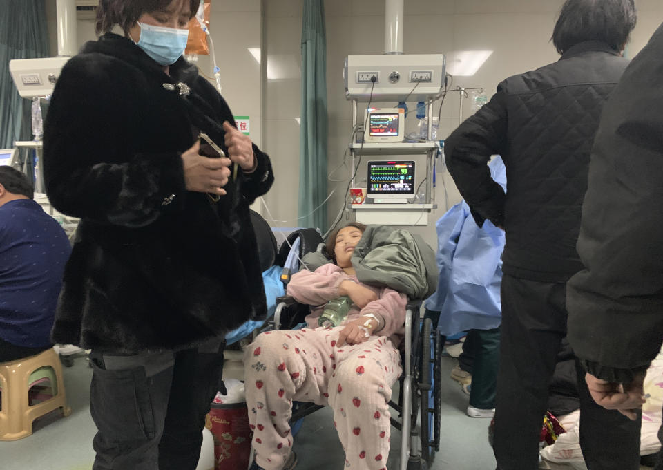 A patient rests in a wheelchair at the emergency department of the Langfang No. 4 People's Hospital in Bazhou city in northern China's Hebei province on Thursday, Dec. 22, 2022. As China grapples with its first-ever wave of COVID mass infections, emergency wards in the towns and cities to Beijing's southwest are overwhelmed. Intensive care units are turning away ambulances, residents are driving sick relatives from hospital to hospital, and patients are lying on floors for a lack of space. (AP Photo/Dake Kang)