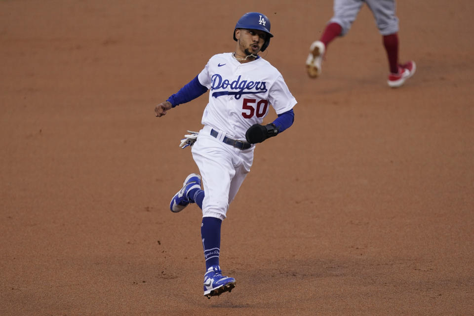 Los Angeles Dodgers' Mookie Betts runs to third base after Justin Turner singled to right field during the first inning of a baseball game against the Los Angeles Angels, Saturday, Sept. 26, 2020, in Los Angeles. (AP Photo/Ashley Landis)