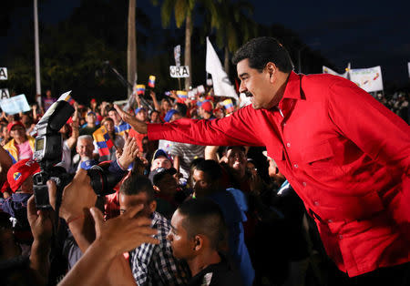 Venezuela's President Nicolas Maduro (R) greets supporters as he arrives to a pro-government rally at Campo Carabobo in Valencia, Venezuela December 6, 2016. Miraflores Palace/Handout via REUTERS