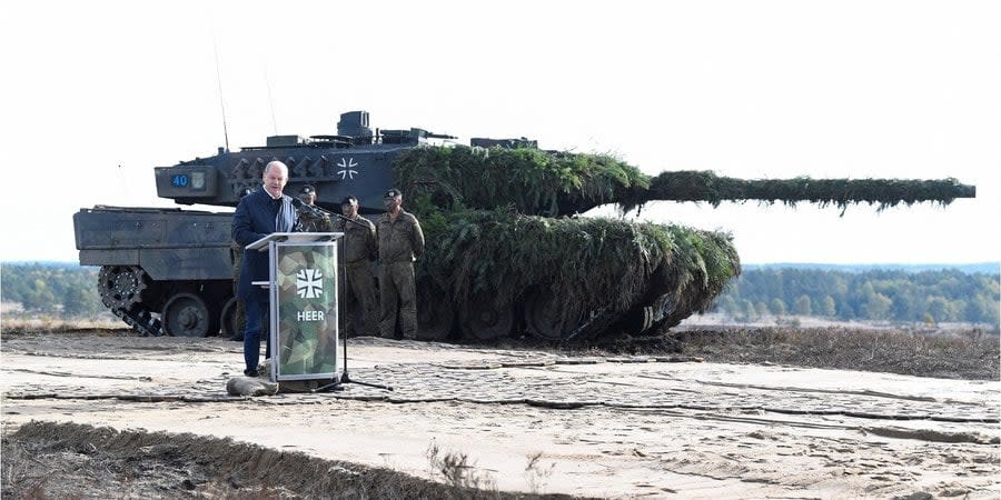 German Chancellor Olaf Scholz speaks against the backdrop of a Leopard 2 tank at the Bundeswehr military base in Bremen, October 2022