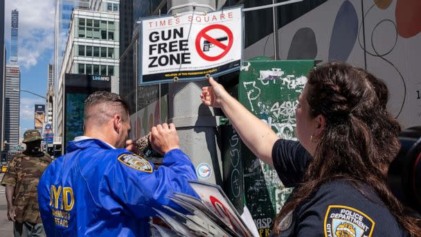 PHOTO: New York City police officers instal signs that read 'gun free zone' at Times Square as new gun laws are due to come into effect, in New York, Aug. 31, 2022. (David 