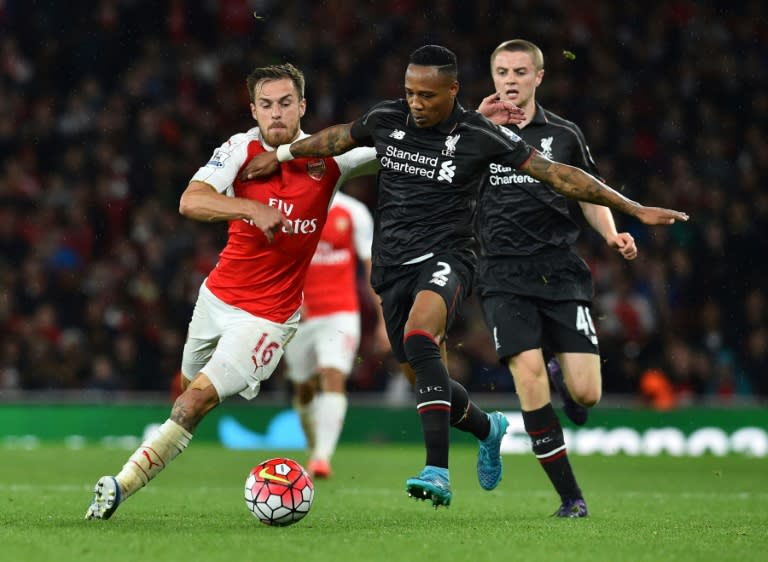 Arsenal's Aaron Ramsey (L) fights for the ball with Liverpool's Nathaniel Clyne during their English Premier League match, at the Emirates stadium in north London, on August 24, 2015