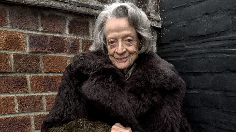 Maggie Smith, 88, wears a floor-length faux fur coat. - Juergen Teller