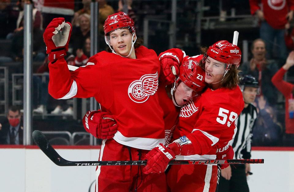 Detroit Red Wings left wing Lucas Raymond (23) celebrates with defenseman Moritz Seider (53) and left wing Tyler Bertuzzi (59) after scoring against the Vegas Golden Knights during the first period at Little Caesars Arena in Detroit on Sunday, Nov. 7, 2021.