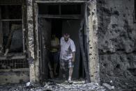 People come out from their houses after shelling in Donetsk, on July 29, 2014