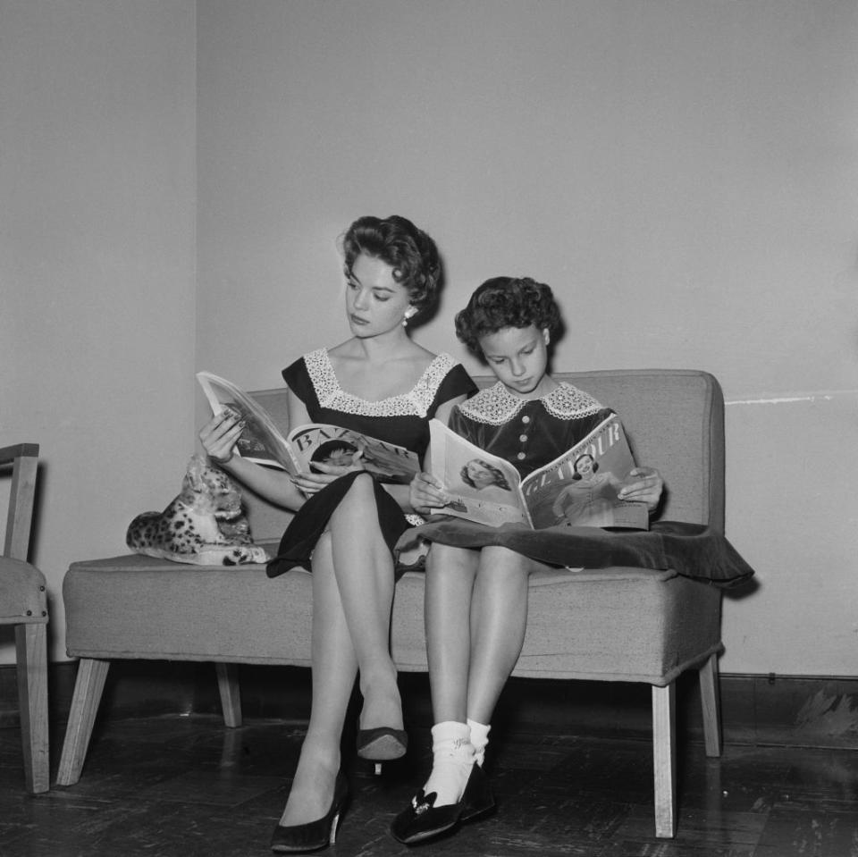 natalie and lana reading magazines on the couch