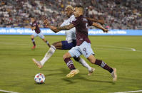 Colorado Rapids forward Andre Shinyashiki, front, moves the ball past FC Dallas defender Nkosi Burgess during the second half of an MLS soccer match Wednesday, July 21, 2021, in Commerce City, Colo. The Rapids won 2-0. (AP Photo/David Zalubowski)