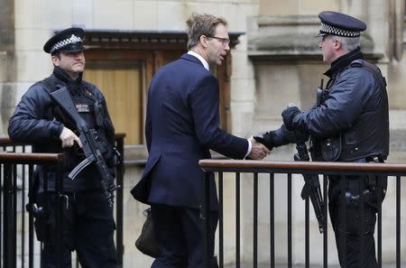 British Member of Parliament Tobias Ellwood shakes hands with an armed police officer as he arrives at the Houses of Parliament, following a recent attack in Westminster, London, Britain March 24, 2017. REUTERS/Darren Staples