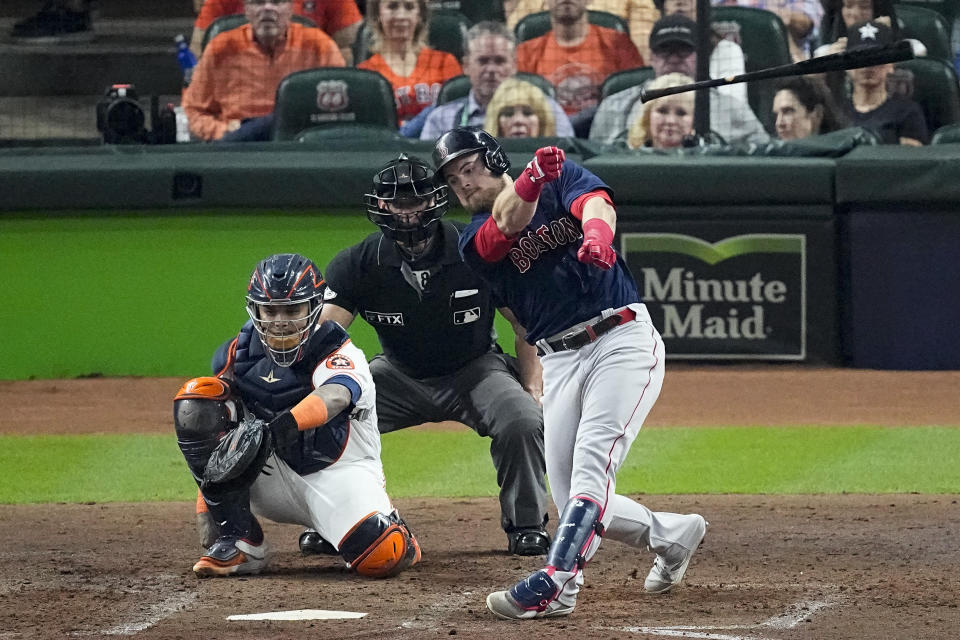 Boston Red Sox's Christian Arroyo loses his bat during the fifth inning in Game 6 of baseball's American League Championship Series against the Houston Astros Friday, Oct. 22, 2021, in Houston. (AP Photo/Sue Ogrocki)