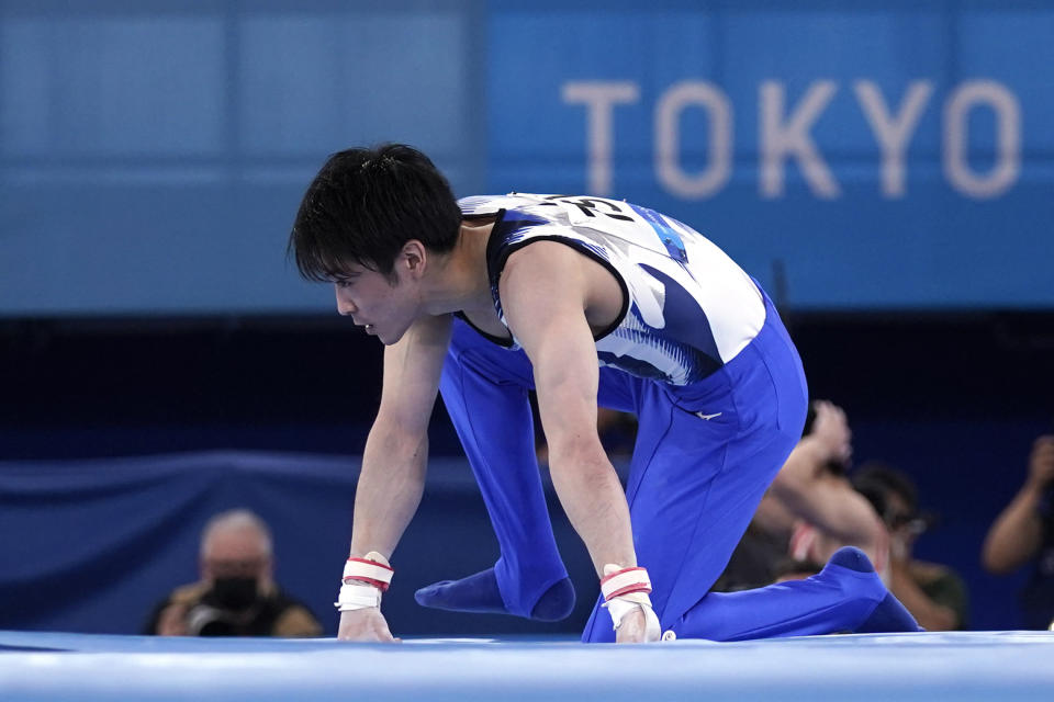 Kohei Uchimura, of Japan, falls from the horizontal bar during the men's artistic gymnastic qualifications at the 2020 Summer Olympics, Saturday, July 24, 2021, in Tokyo. (AP Photo/Gregory Bull)