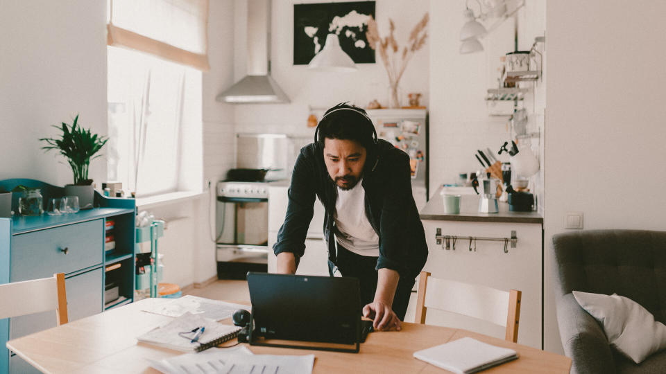 Photo series of japanese man working from home as a freelancer, making conference calls and discussing projects.