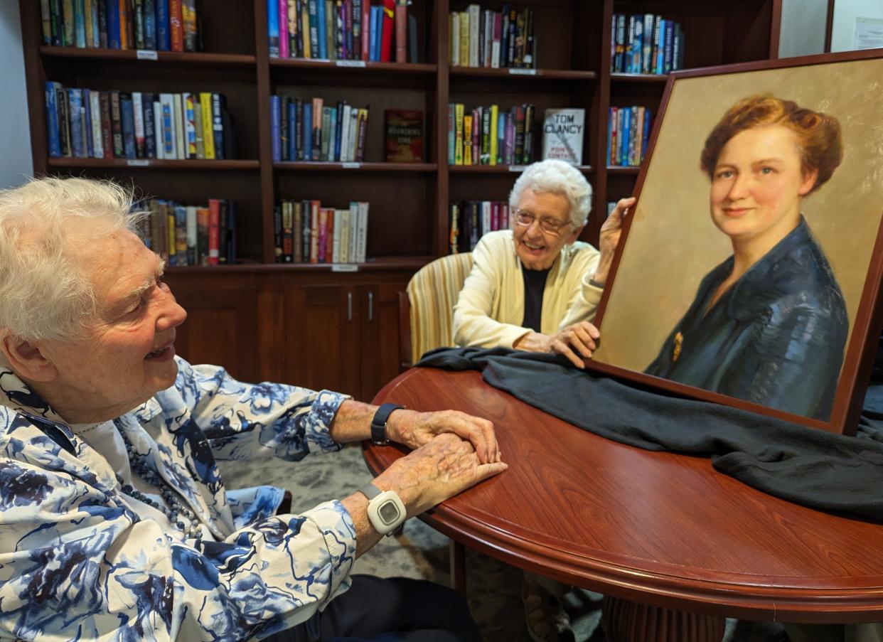 This painting of Myrtle Hubbard by artist Rose Frantzen was commissioned for a library at Oaknoll Retirement Residence in Iowa City which will be named in Hubbard’s honor next week. At left is the daughter of the late honoree, Dorothy Housel, now an Oaknoll resident, with committee chairperson Jean Lloyd-Jones.
