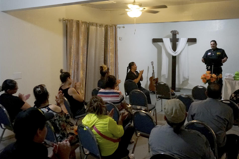 Oscar Andrade speaks to volunteers with the rescue and recovery group Capellanes del Desierto (Desert Chaplains) at La Iglesia en el Camino (The Church on the Way), Tuesday, Sept 6, 2022 in Tucson, Ariz. The pastor heads a group that provides recovery efforts for families of missing migrants. Andrade has received over 400 calls from families in Mexico and Central America whose relatives, sick, injured or exhausted, were left behind by smugglers in the borderlands. (AP Photo/Giovanna Dell'Orto)