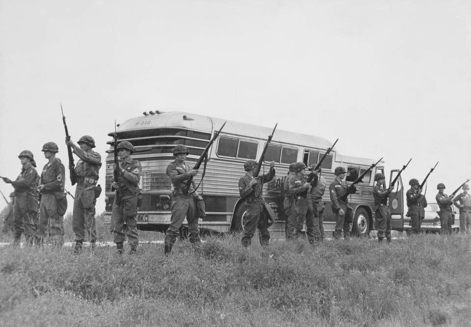 Members of the U.S. military guard a bus carrying civil rights activists known as Freedom Riders while they travel into Jackson, Mississippi, in May 1961. (Photo: Archive Photos/Getty Images)