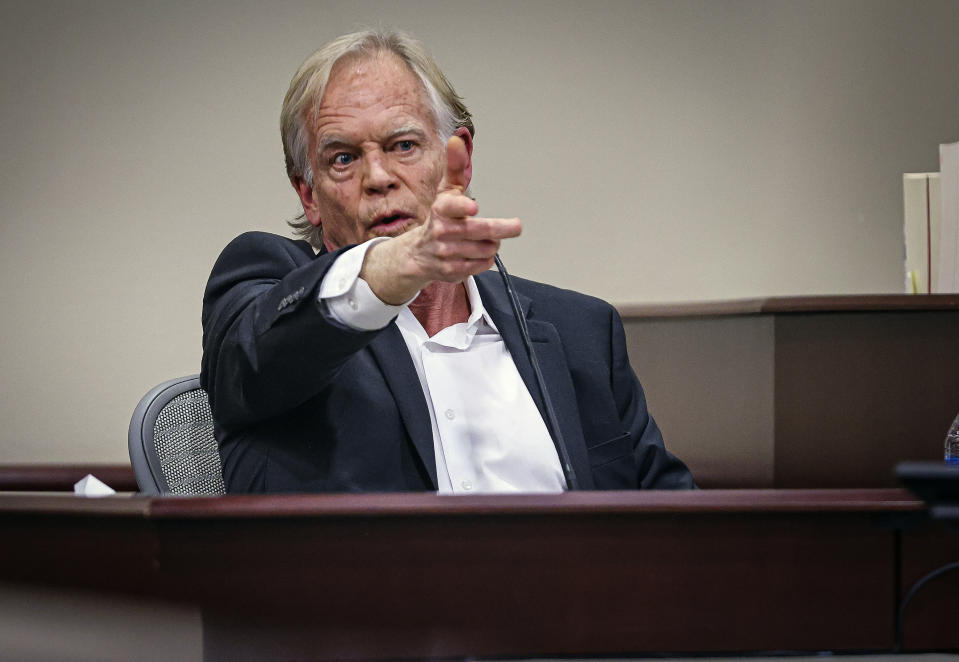 David Halls, former first assistant director on "Rust," uses his hand to mimic a gun to recreate a gesture that Alec Baldwin used while on set the day cinematographer Halyna Hutchins was fatally shot on set, while testifying during Hannah Gutierrez-Reed's involuntary manslaughter trial in state district court in Santa Fe, N.M., Thursday, Feb. 29, 2024. (Gabriela Campos/Santa Fe New Mexican via AP, Pool)