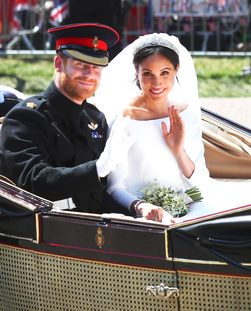 Prince Harry and Meghan Markle on their carriage procession following their nuptials in St. George's Chapel