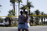 <p>Two women embrace in front of the concert venue where a mass shooting took place on the Las Vegas Strip, Monday, Oct. 2, 2017, in Las Vegas. (Photo: Marcio Jose Sanchez) </p>