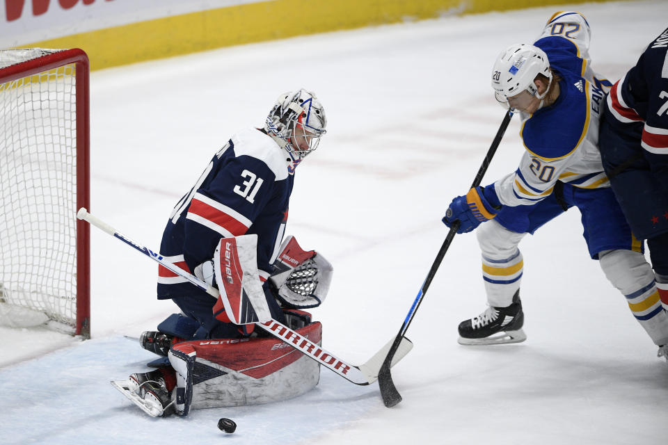 Buffalo Sabres center Cody Eakin (20) works for the puck in front of Washington Capitals goaltender Craig Anderson (31) during the second period of an NHL hockey game Thursday, April 15, 2021, in Washington. (AP Photo/Nick Wass)