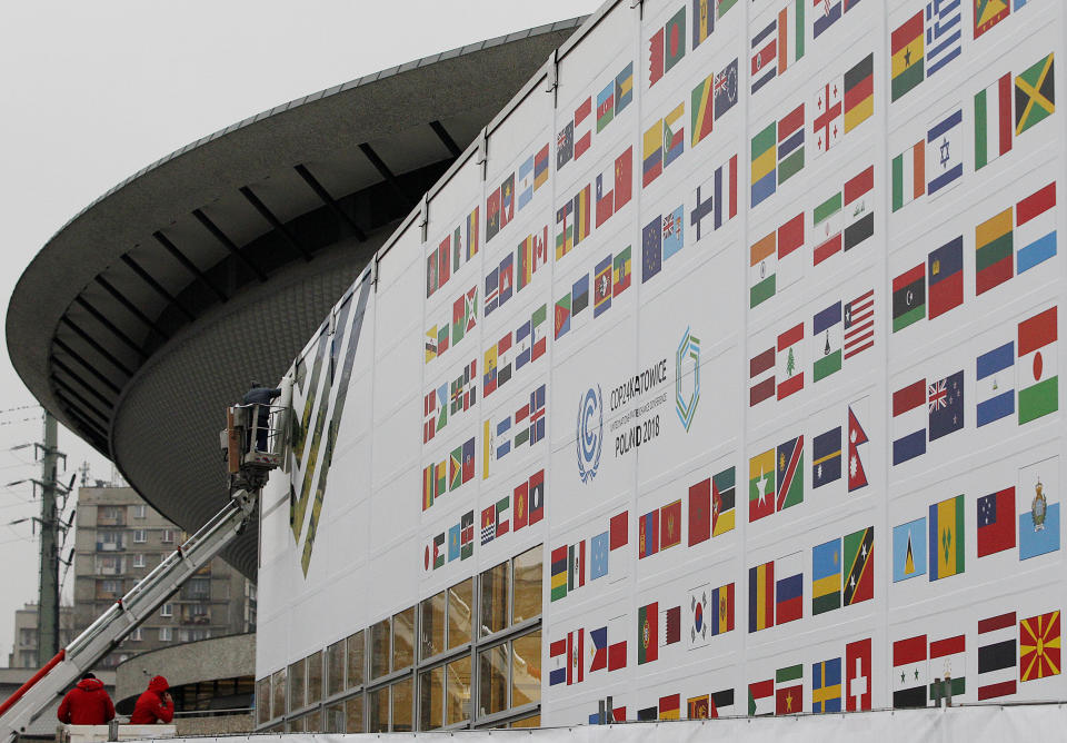 In this Nov. 20, 2018 photo workers decorate the venue of the global climate summit that will be held at the site of the closed 'Katowice' coal mine in the city of Katowice, Poland. The COP 24 UN Climate Change Conference is taking place in Katowice, Poland. Negotiators from around the world are meeting for talks on curbing climate change. (AP Photo/Czarek Sokolowski)