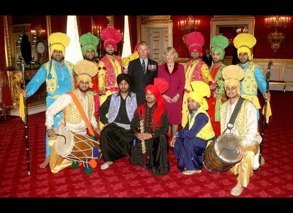 Britain's Prince Charles and Camilla, the Duchess of Cornwall pose for pictures as they met surviving veterans of the Sikh Brigade of the British Army at an event to mark the Sikh religious and cultural festival of Vaisakhi at St James Palace, London.