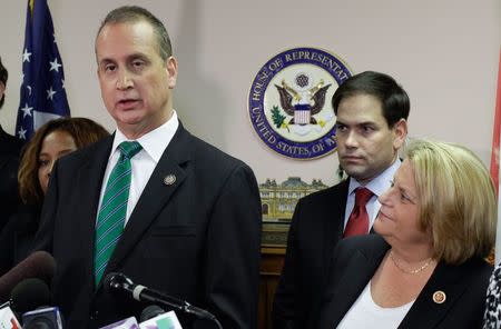 Rep. Mario Diaz-Balart, (R-FL), (L), speaks next to Senator Marco Rubio, (R-FL), and Rep. Ileana Ros-Lehtinen, (R-FL), during a press conference in Miami, Florida December 18, 2014. REUTERS/Javier Galeano