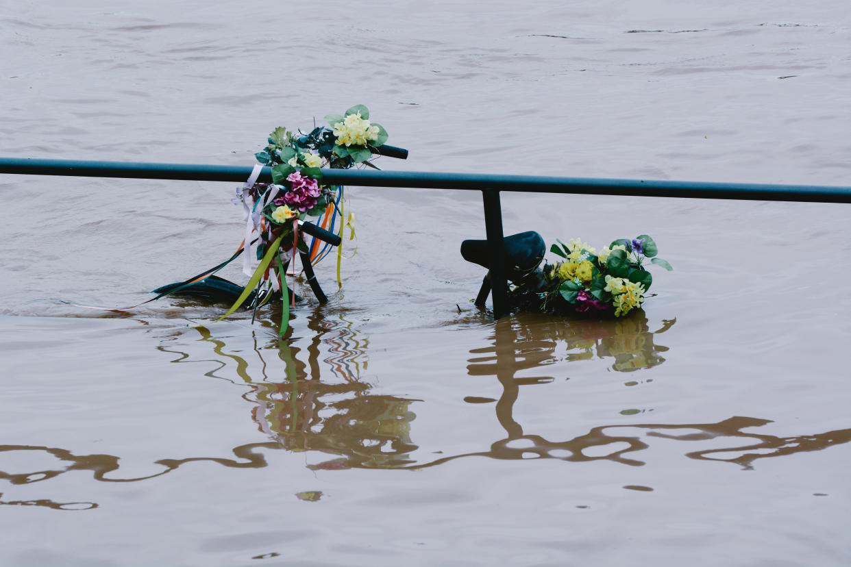 a bicycle is seen under the water from Rhine river in Cologne, Germany on July 15, 2021 as NRW experienced flooding after large amount of rain fell (Photo by Ying Tang/NurPhoto via Getty Images)