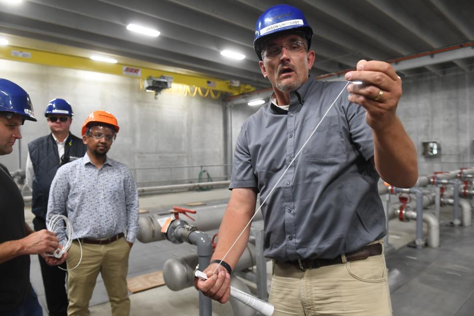 Smithfield Foods Director of Environmental Affairs Jason Lindquist unwinds one of the membrane used in their upgraded bioreacto at Smithsfield Foods in Sioux Falls , South Dakota on Wednesday, August 16, 2023. Thousands of these membranes, which have a hole as thin as a human hair, are used to separate solids from outgoing wastewater as it filters the cords.