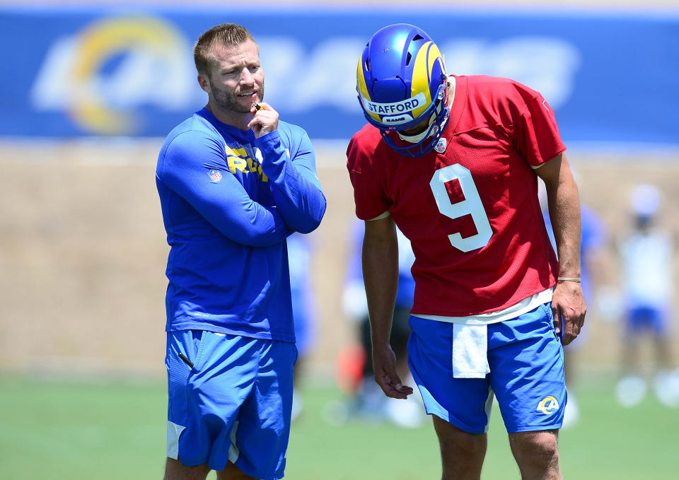 Los Angeles Rams head coach Sean McVay speaks with quarterback Matthew Stafford (9) during organized team activities.