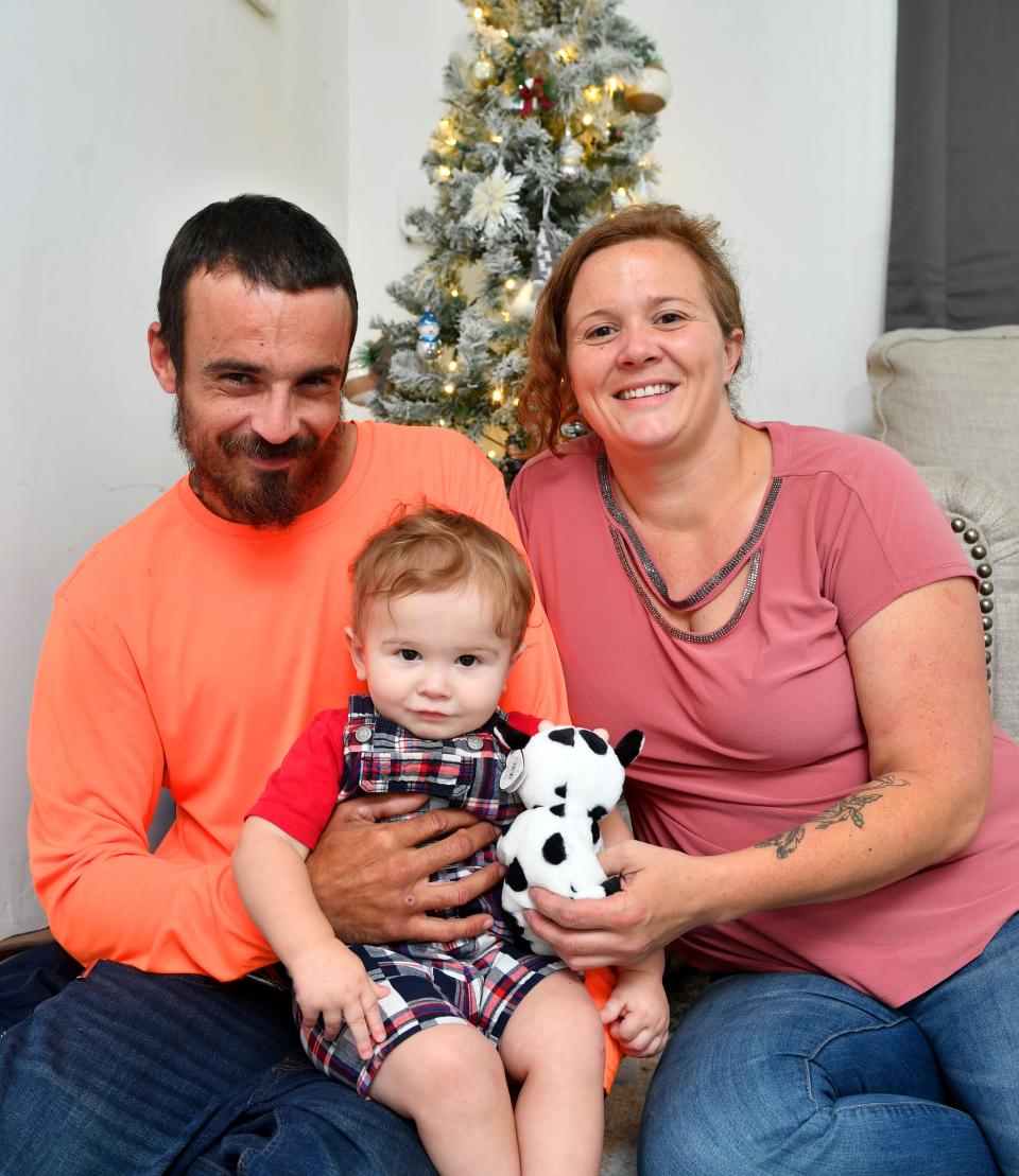 Craig Siringer and Ashley Wedig with their son, Troy, 1, at their home in Englewood.