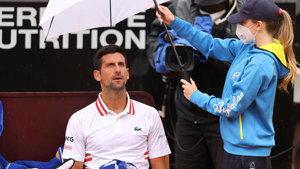 Novak Djokovic, pictured here sheltering under an umbrella at the Italian Open.