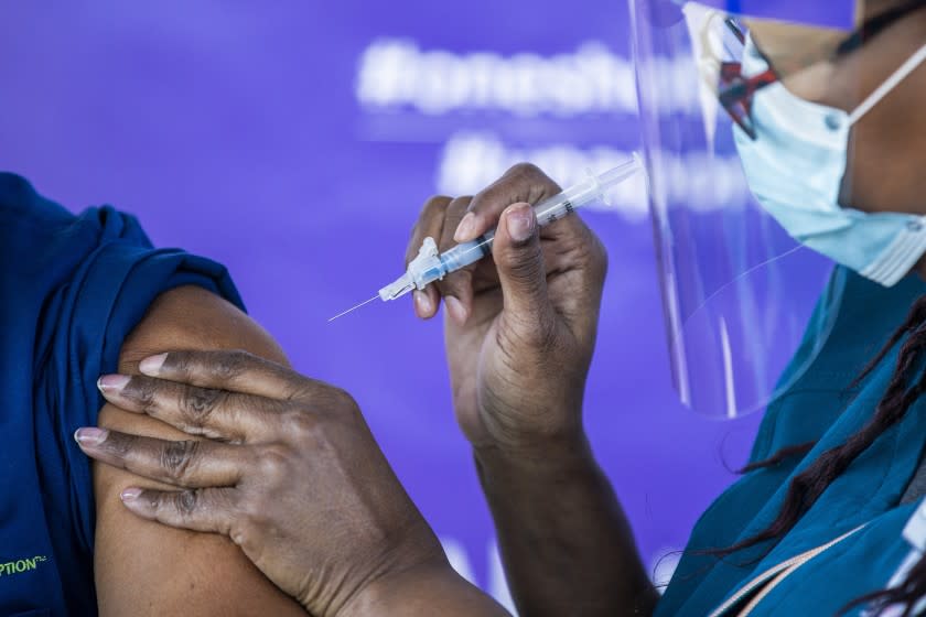 Anaheim, CA - January 28: Darlene Dickens-Jeffers, right, senior manager of infection prevention at AltaMed Health Services, gives a Moderna COVID-19 vaccination to former Los Angeles Mayor Antonio Villaraigosa, who wants to send a message to encourage other seniors to get their vaccination shots at AltaMed Health Services Medical and Dental Group in Anaheim Thursday, Jan. 28, 2021. (Allen J. Schaben / Los Angeles Times)