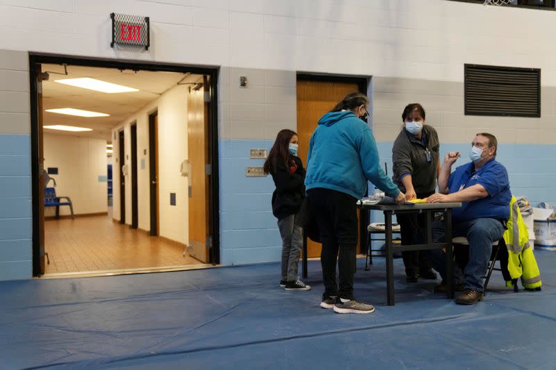 People from rural communities get their coronavirus disease (COVID-19) vaccinations at Menominee Indian High School in Menominee, Wisconsin
