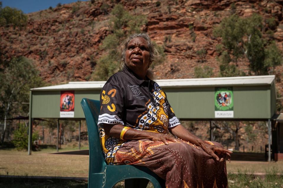 Teacher Tarna Andrews sits in the school grounds in Areyonga (Reuters)