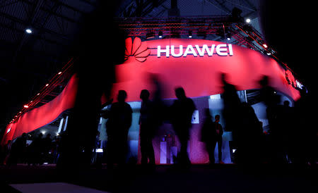 Visitors walk past Huawei's booth during Mobile World Congress in Barcelona, Spain, February 27, 2017. REUTERS/Eric Gaillard/Files