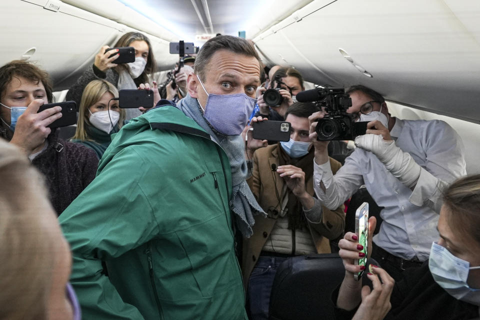 FILE - In this Jan. 17, 2021, file photo, Alexei Navalny is surrounded by journalists in a plane before a flight to Moscow in the Berlin Brandenburg Airport. Rattled by nationwide protests over Navalny, Russian authorities are moving rapidly to block any new ones – from putting legal pressure on his allies to launching a campaign to discredit the demonstrations. (AP Photo/Mstyslav Chernov, File)