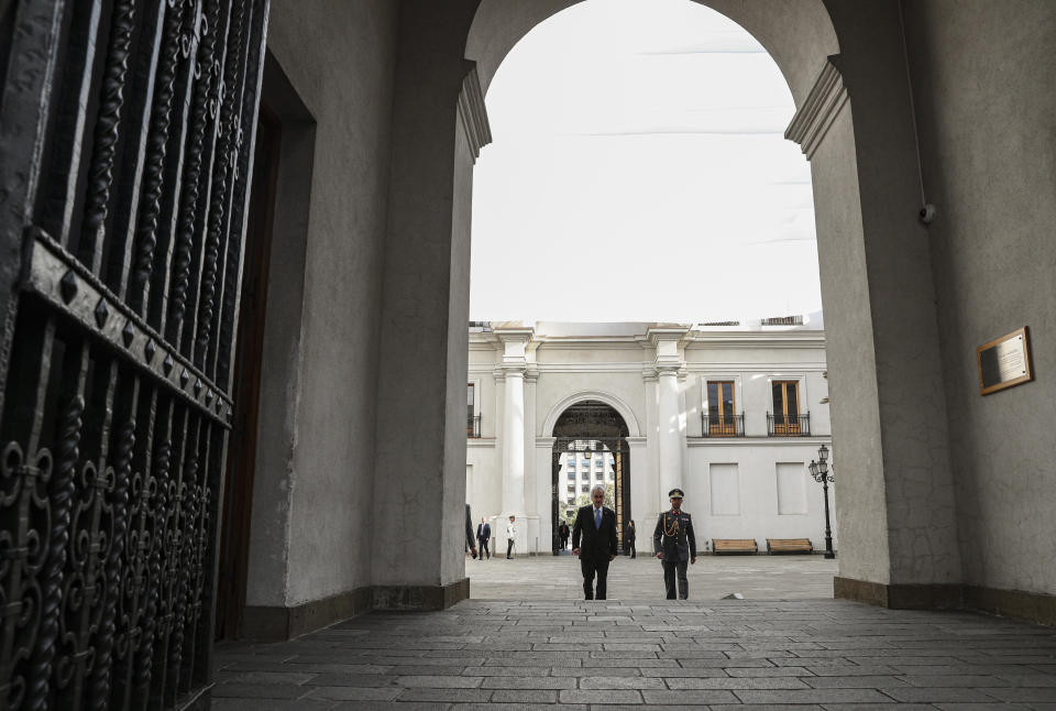 Chile's President Sebastian Pinera arrives to La Moneda presidential palace in Santiago, Chile, Monday, Nov. 11, 2019. The government announced Sunday it has agreed to start the process to write a new Constitution for the country, one of the most repeated demands of protesters who have taken to the streets in often violent demonstrations in recent weeks. (AP Photo/Esteban Felix)