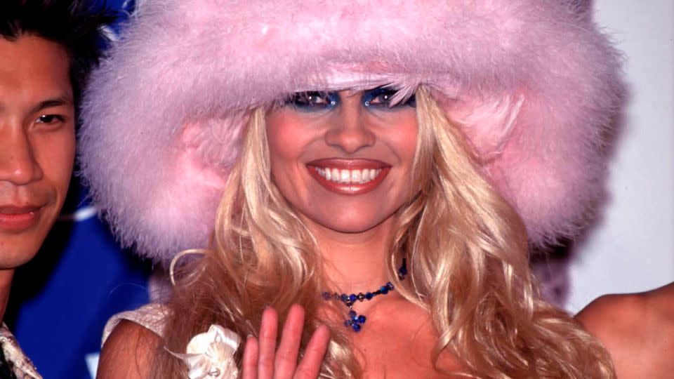 Pam Anderson's feathered pink hat stood out during a night of many looks at the 1999 MTV VMAs. - Evan Agostini/Hulton Archive/Getty Images